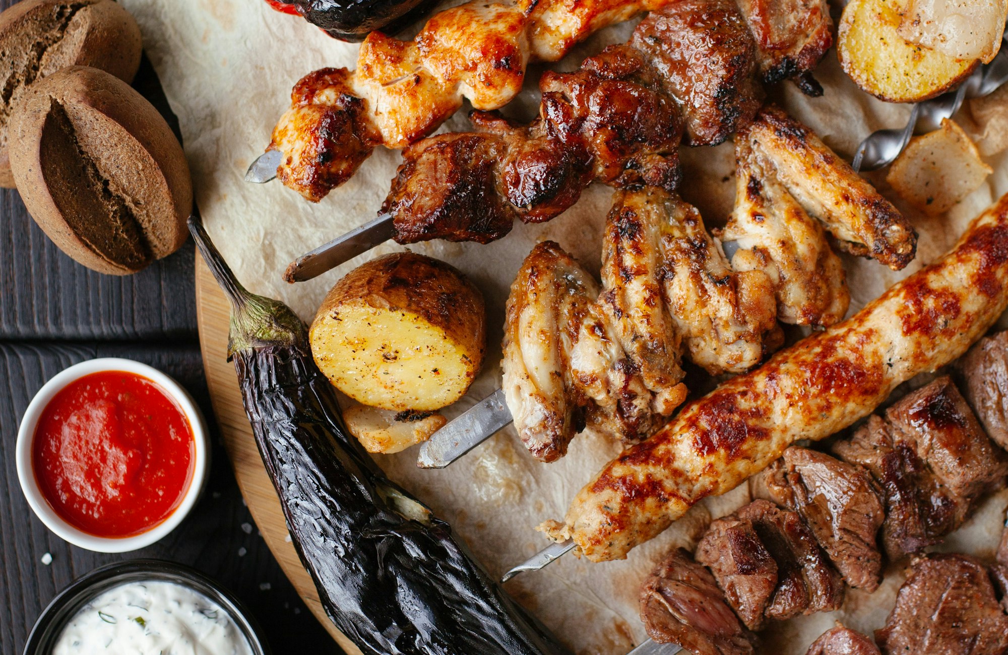 Grilled skewers over charcoal